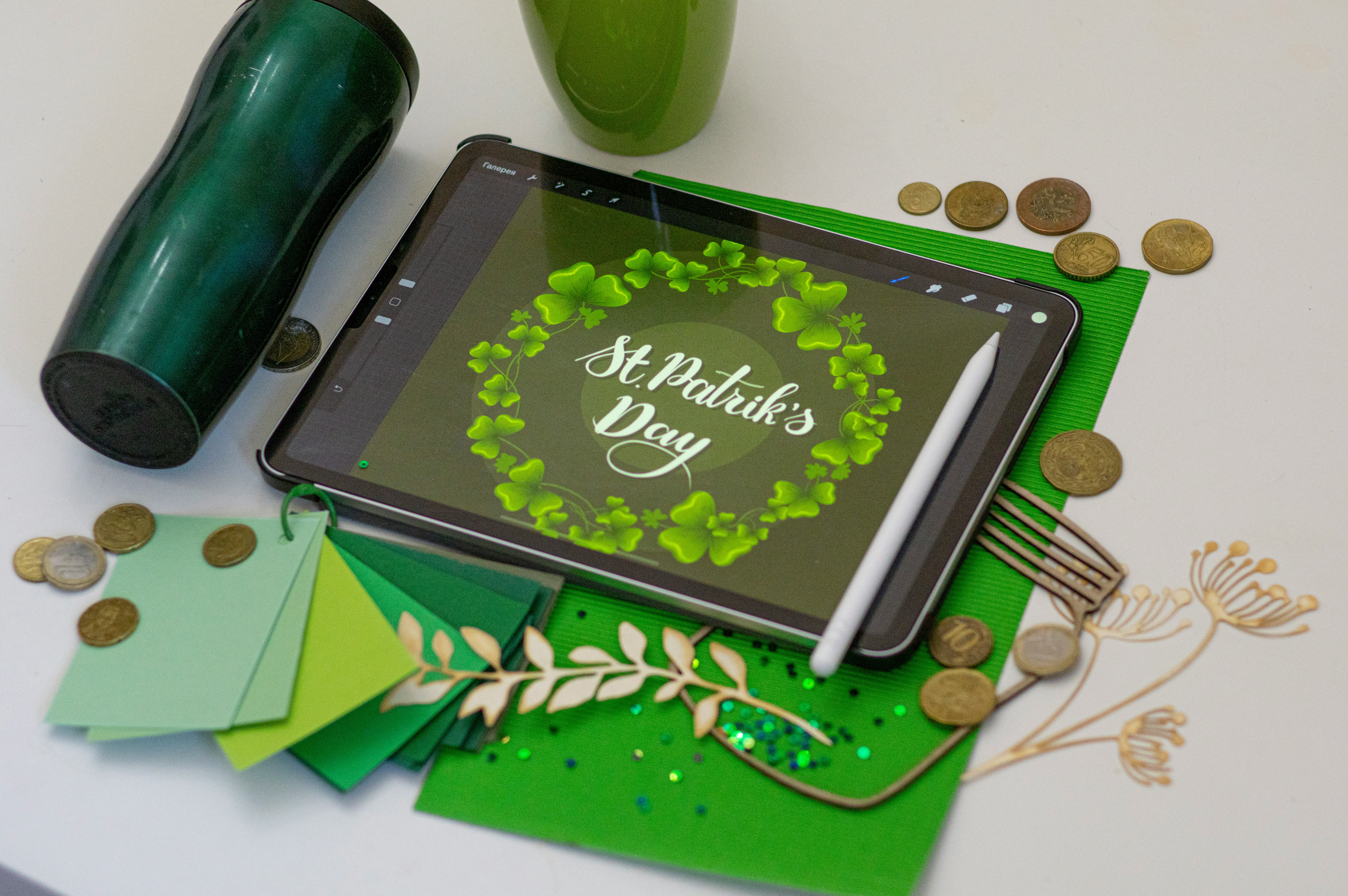 Digital artwork display for St. Patrick's Day with green decorations and craft materials.